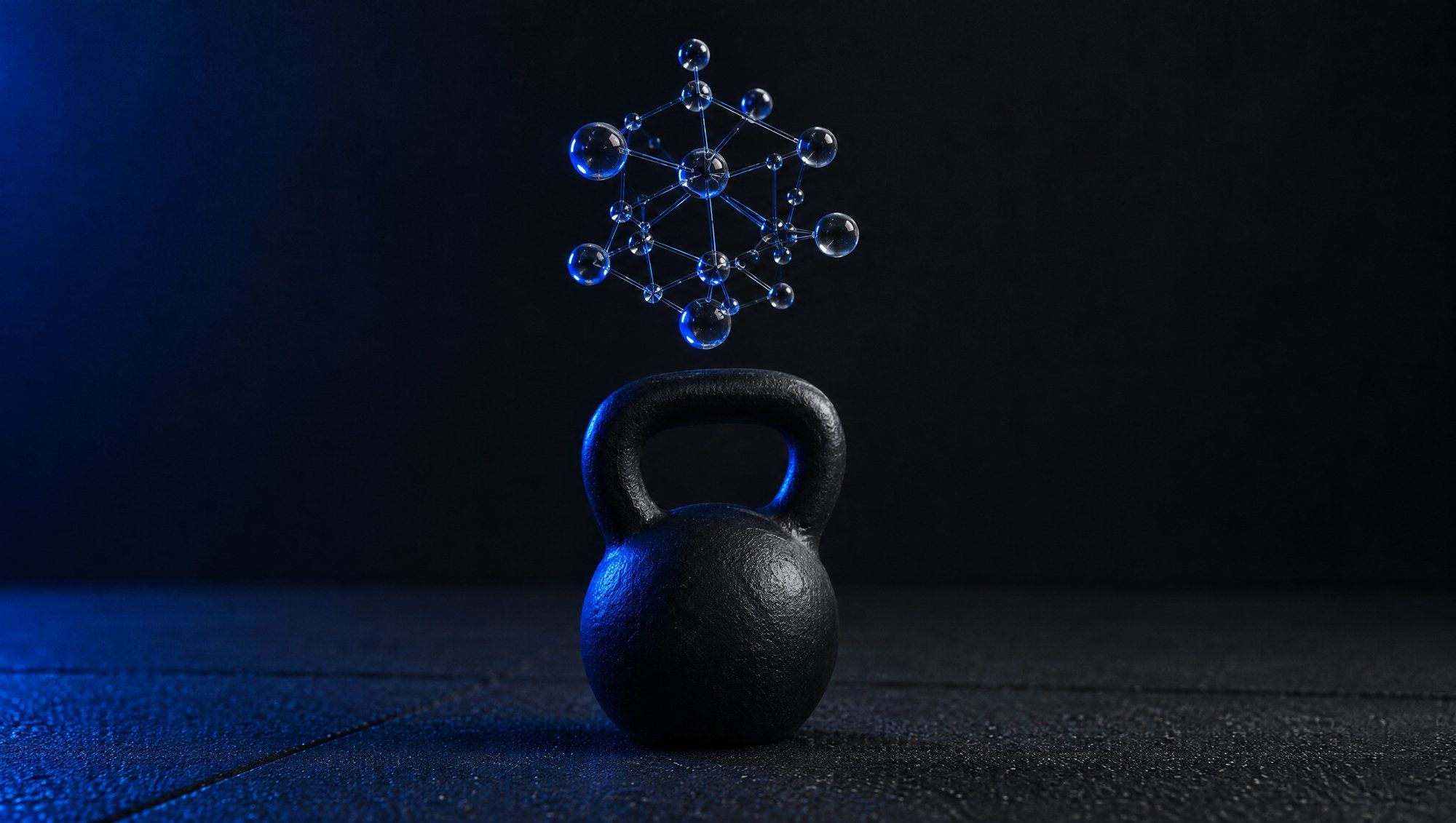 A black kettlebell on a dark gym floor with a small lattice of glass spheres and rods floating above it, edged in navy-blue light.